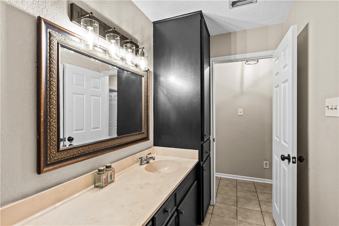 5213 Inverness Drive Corpus Christi, TX 78413 - Photo 21 of 23 a bathroom with a double vanity sink mirror and
