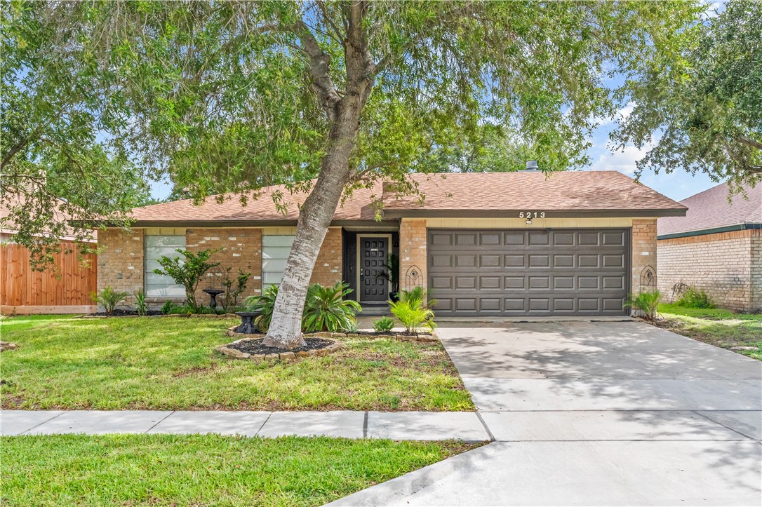5213 Inverness Drive Corpus Christi, TX 78413 - Photo 22 of 23 a front view of a house with a yard and porch