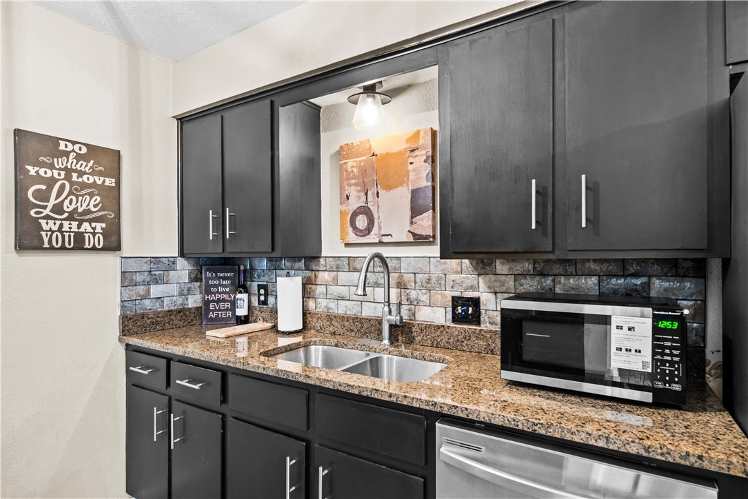 5213 Inverness Drive Corpus Christi, TX 78413 - Photo 9 of 23 a kitchen with stainless steel appliances granite countertop a sink stove and cabinets