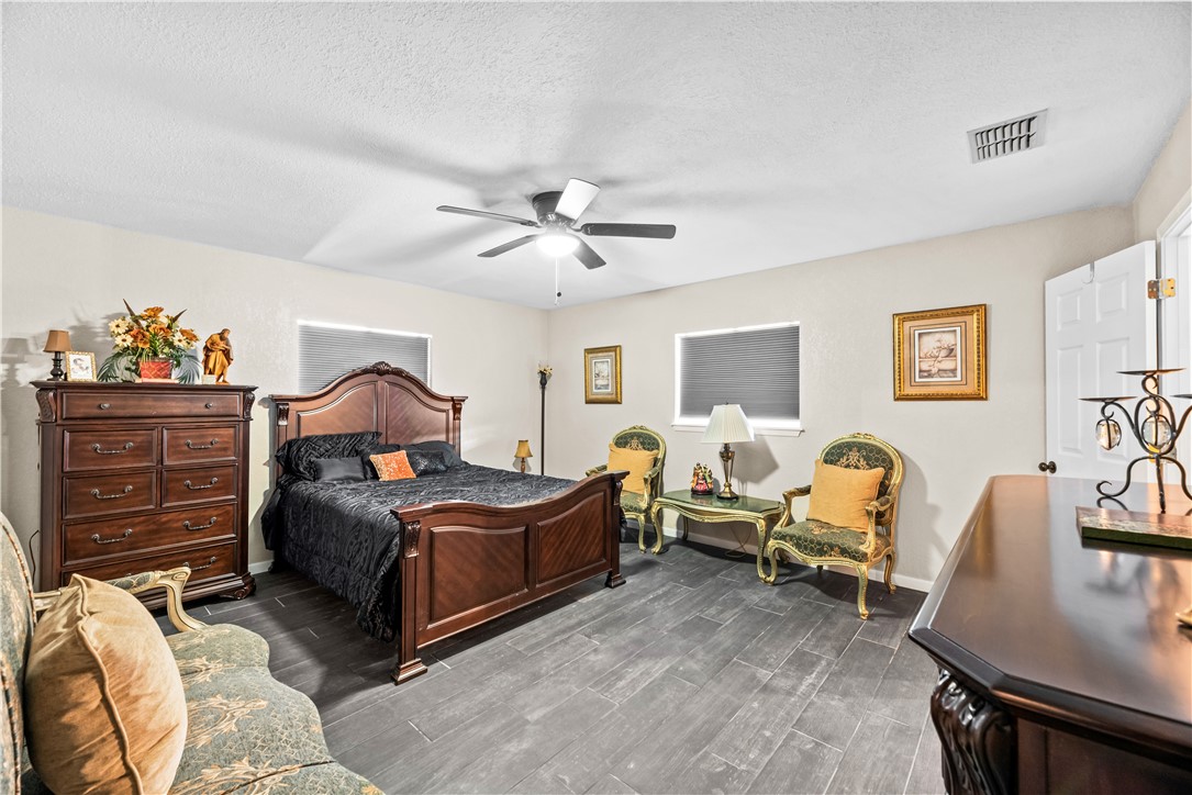 5213 Inverness Drive Corpus Christi, TX 78413 - Photo 10 of 23 a bedroom with bed and a couch