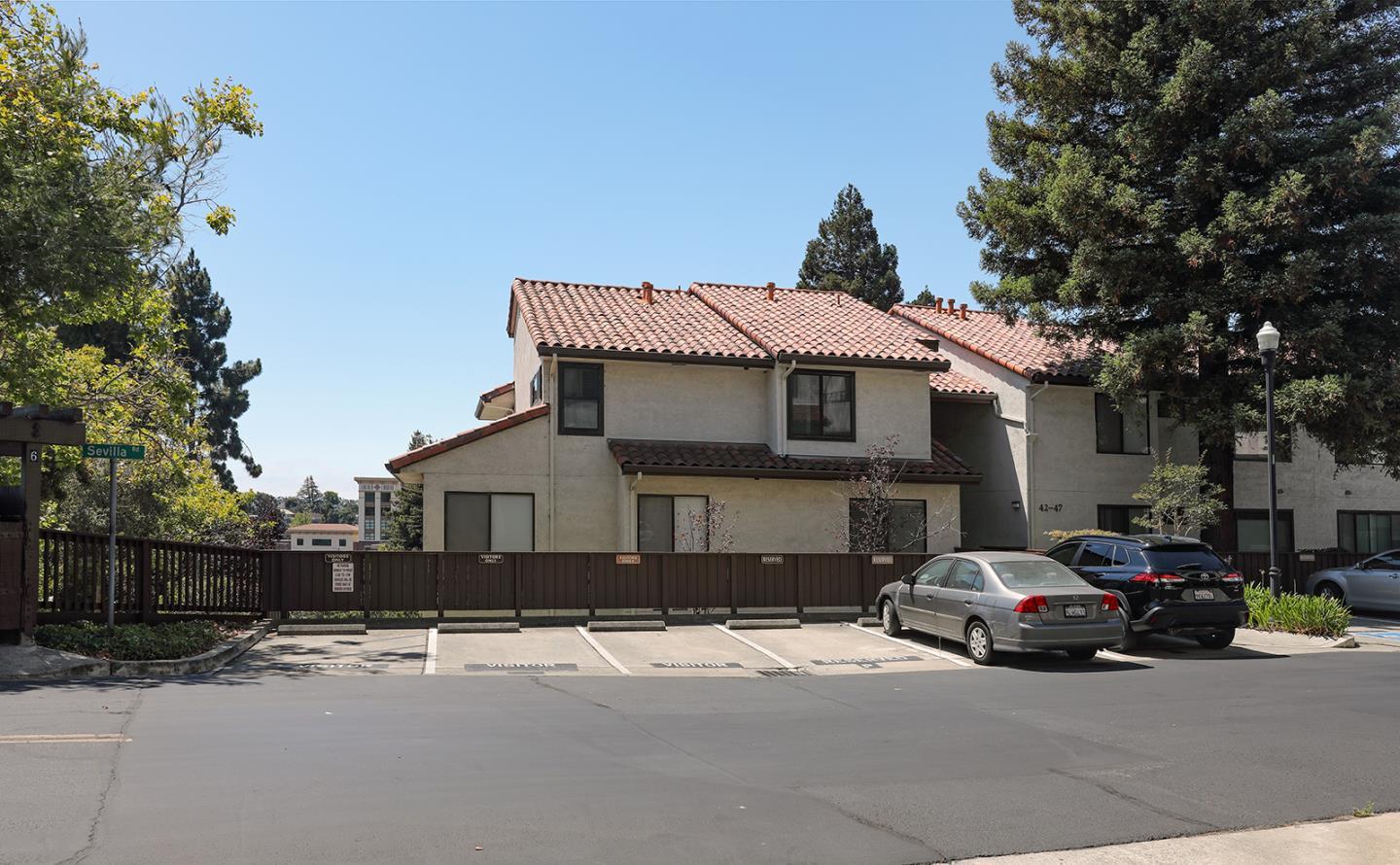 a front view of a house with a yard and parking