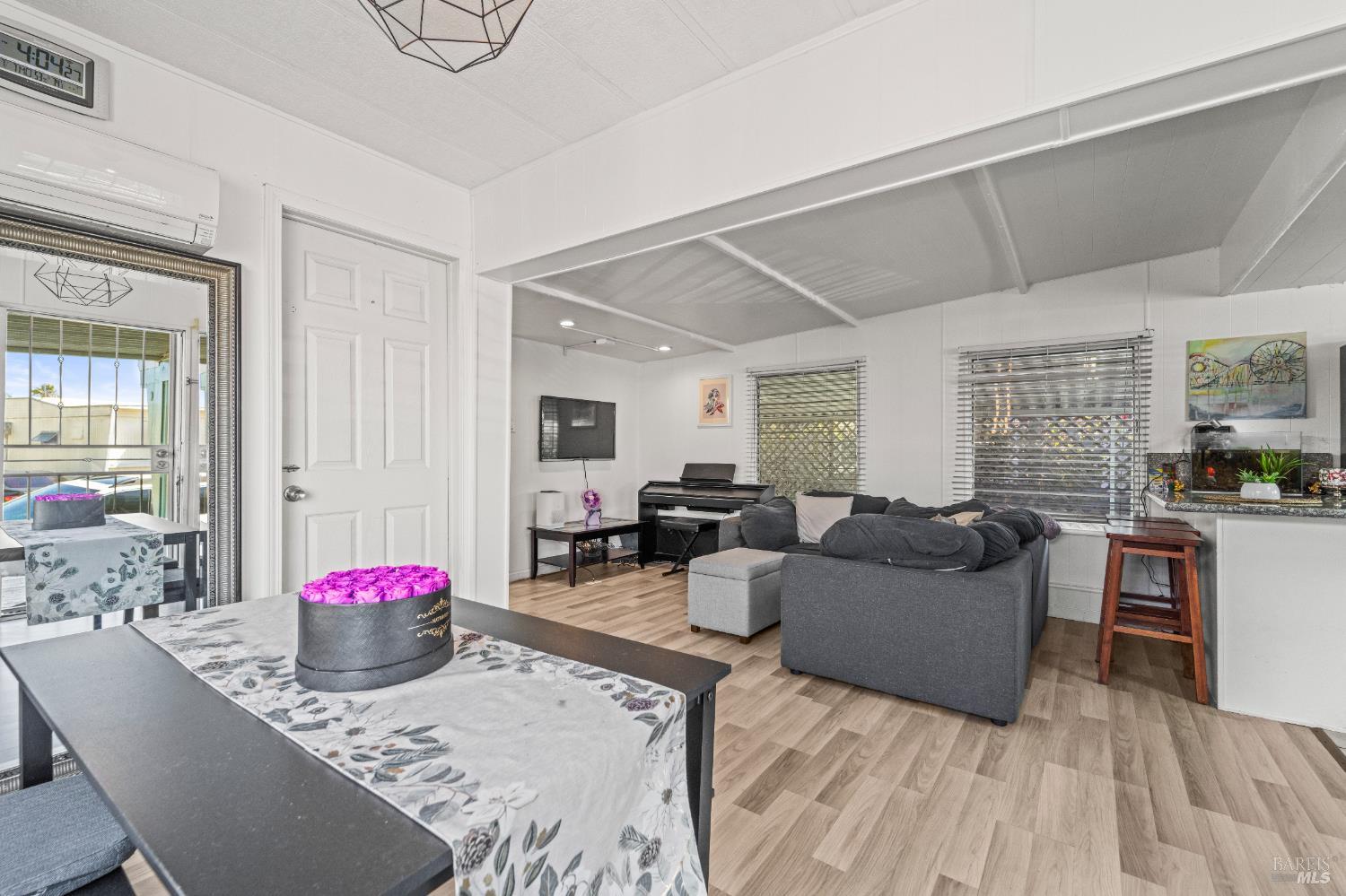 a living room with furniture and a wooden floor