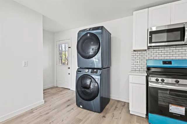 a kitchen with a stove top oven and cabinets