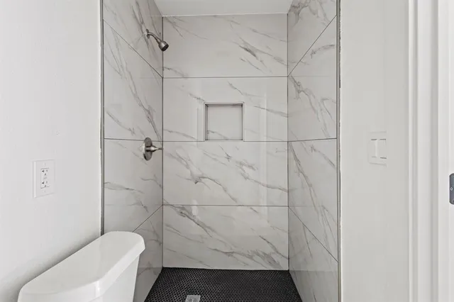 a bathroom with a toilet and shower