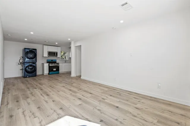 a view of a kitchen with a sink and a refrigerator