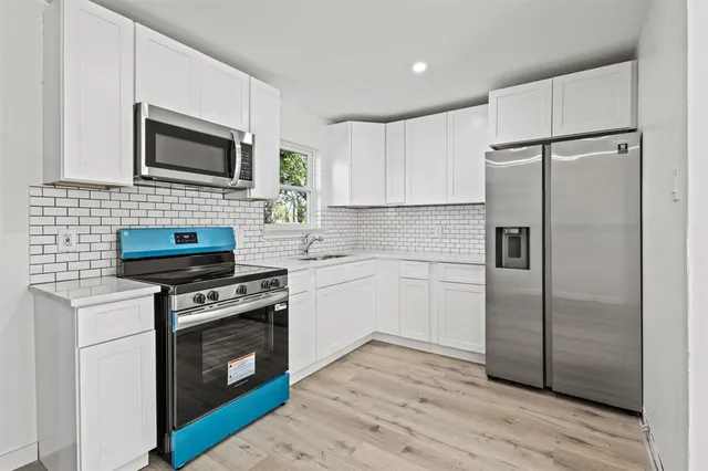 a kitchen with a stove microwave and refrigerator