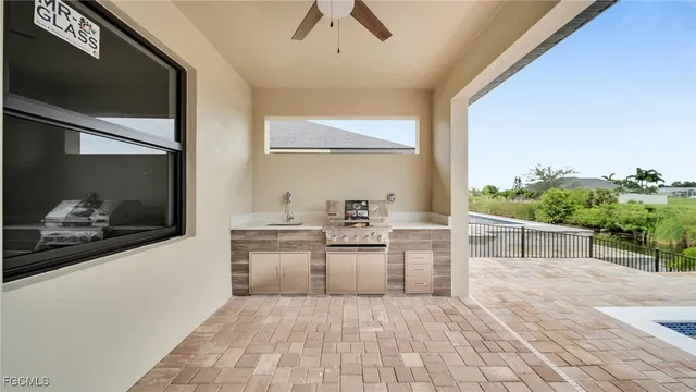 a view of a kitchen with a sink and dishwasher with wooden floor