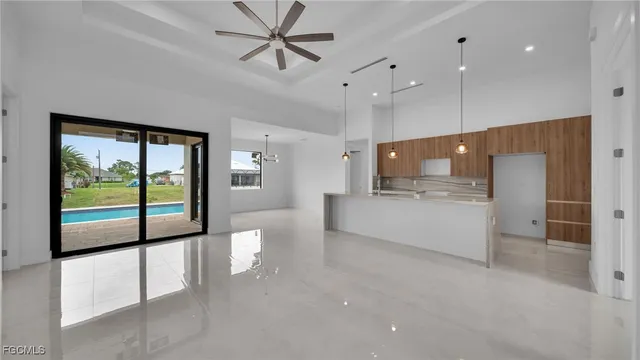 a view of an empty room with a kitchen