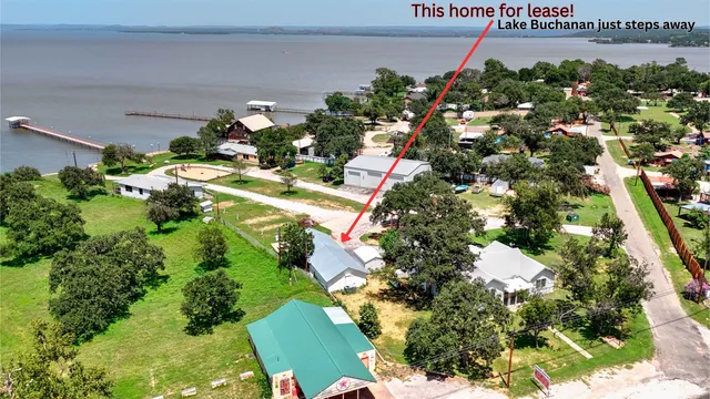 an aerial view of a house with yard swimming pool and outdoor seating