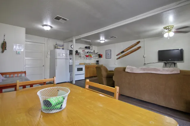 a storage & utility room with lots of wooden furniture