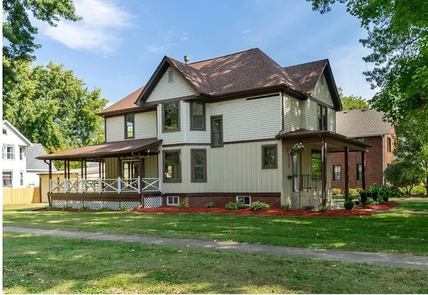 a front view of a house with a yard table and chairs