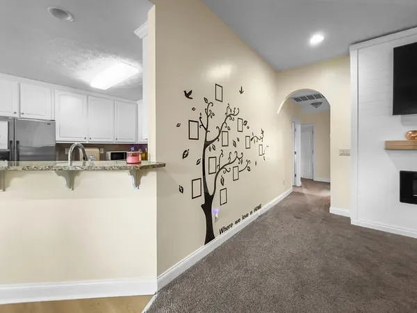 a view of living room with stainless steel appliances with kitchen view