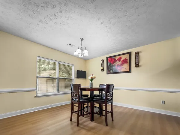 a view of a dining room with furniture and wooden floor