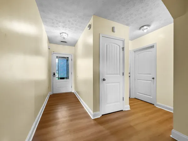 a view of a hallway with wooden floor