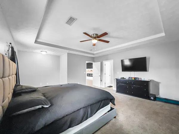 a bedroom with a bed and a flat screen tv