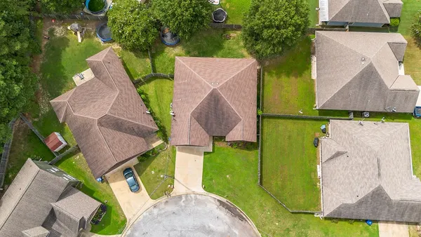 an aerial view of a house with outdoor space and a lake view