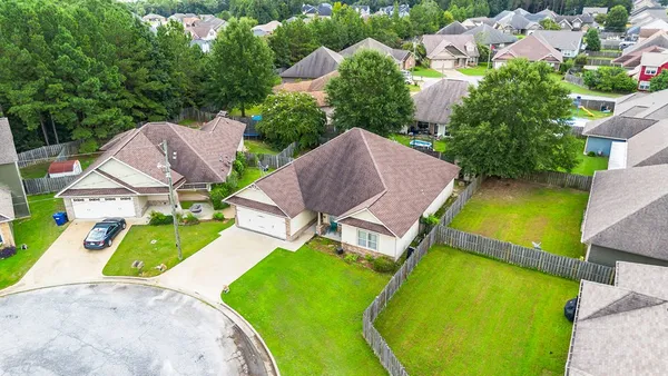 an aerial view of a house with a swimming pool and garden