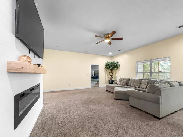 a living room with furniture and a fireplace