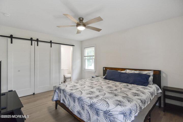 7 Kaylen Place Hazlet, NJ 07730 - Photo 21 of 22 a bedroom with a large bed and a chandelier