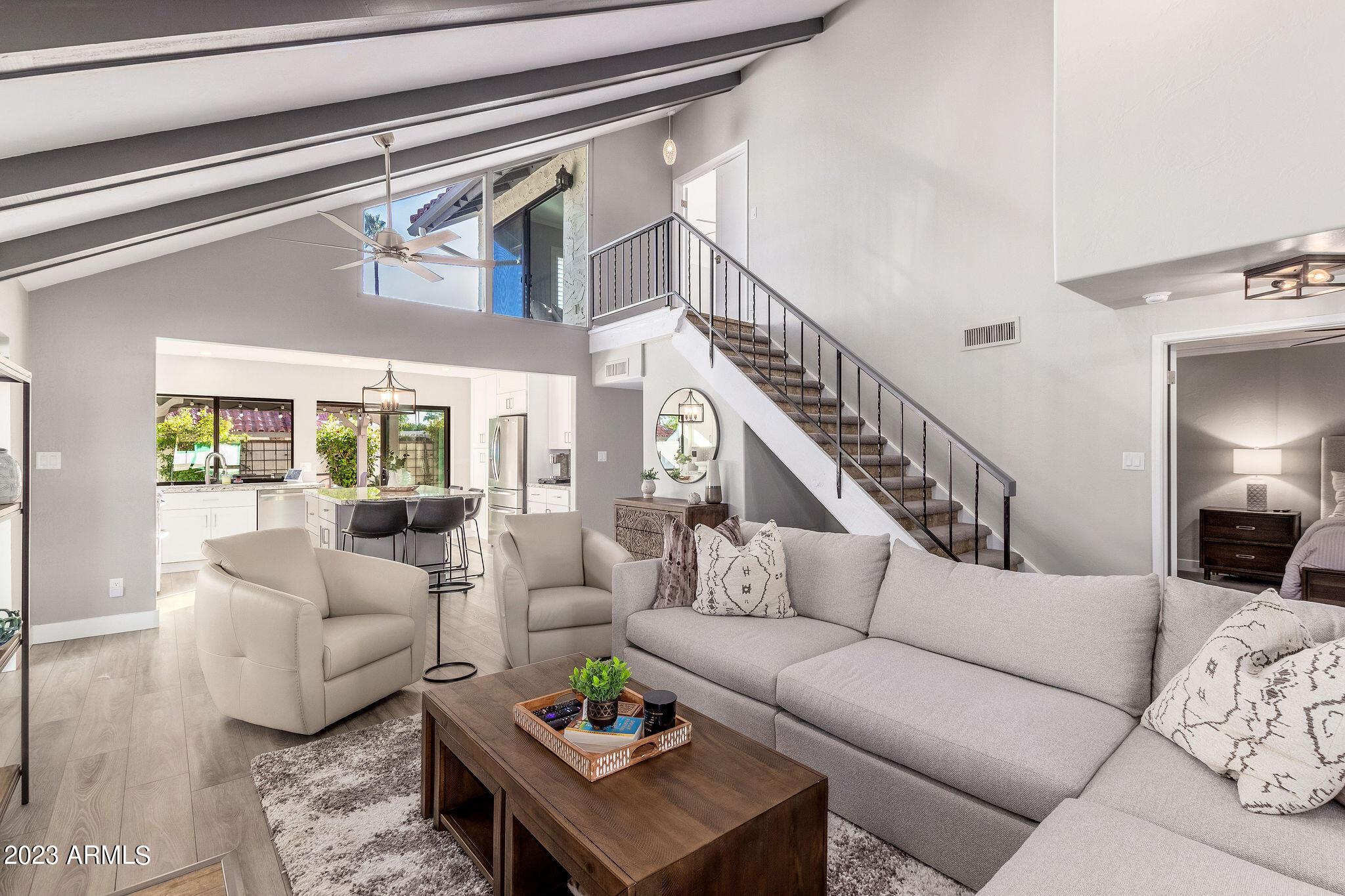 a living room with furniture and wooden floor
