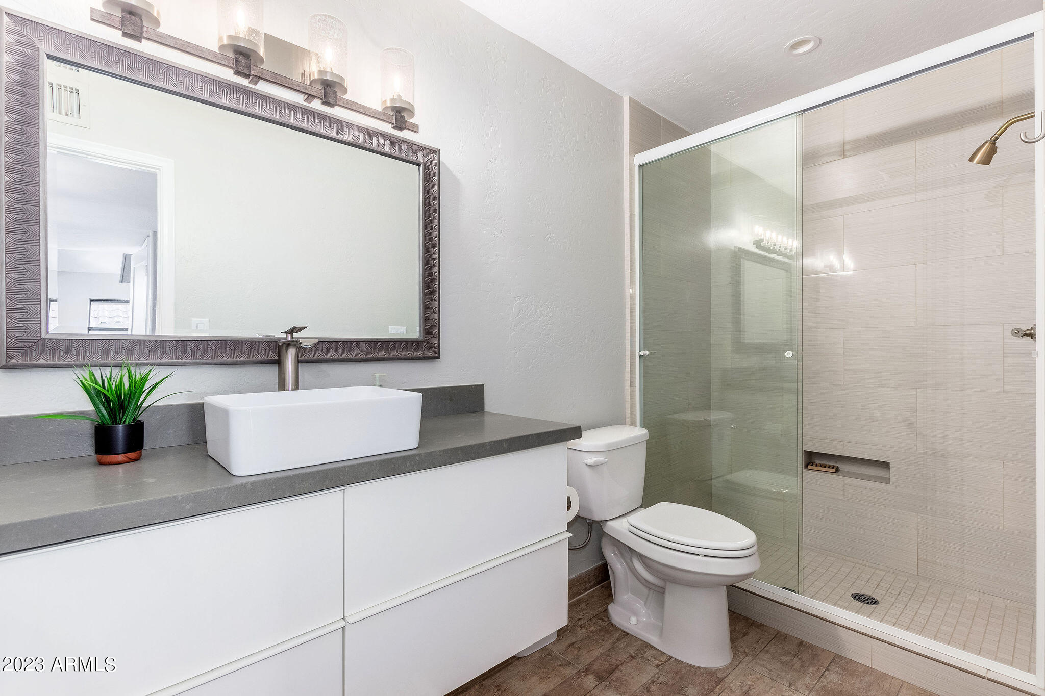 5822 North Scottsdale Road Paradise Valley, AZ 85253 - Photo 18 of 31 a bathroom with a granite countertop sink a toilet and shower