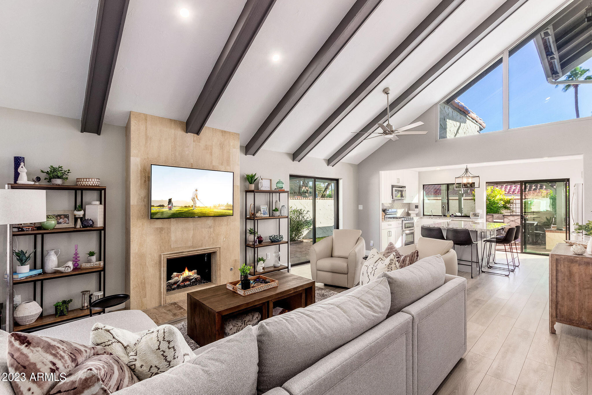 5822 North Scottsdale Road Paradise Valley, AZ 85253 - Photo 2 of 31 a living room with furniture a fireplace and a flat screen tv