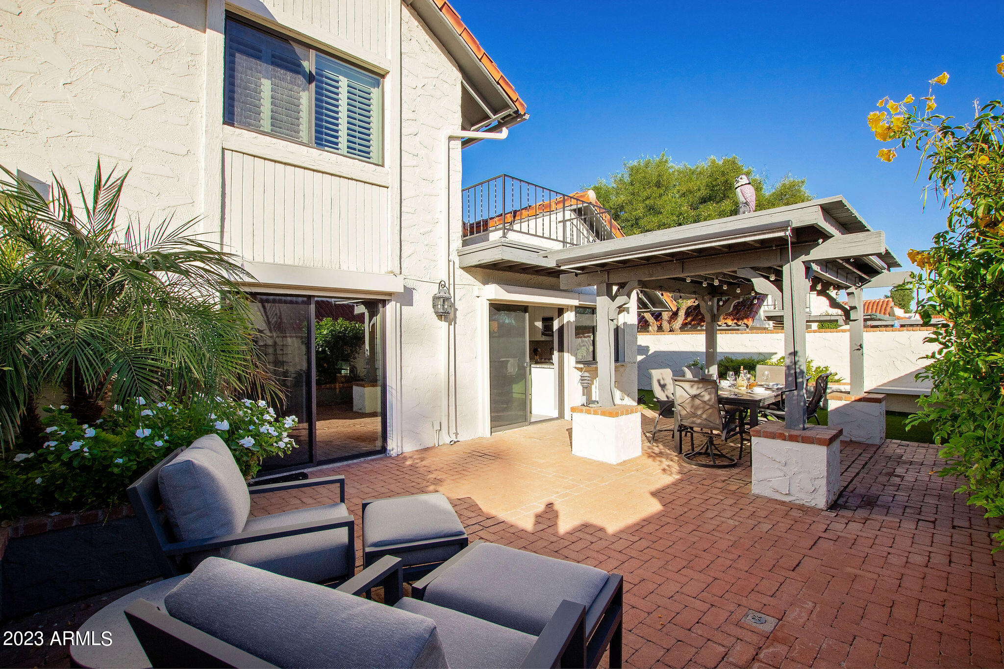 5822 North Scottsdale Road Paradise Valley, AZ 85253 - Photo 22 of 31 a view of a patio with couches table and chairs and potted plants