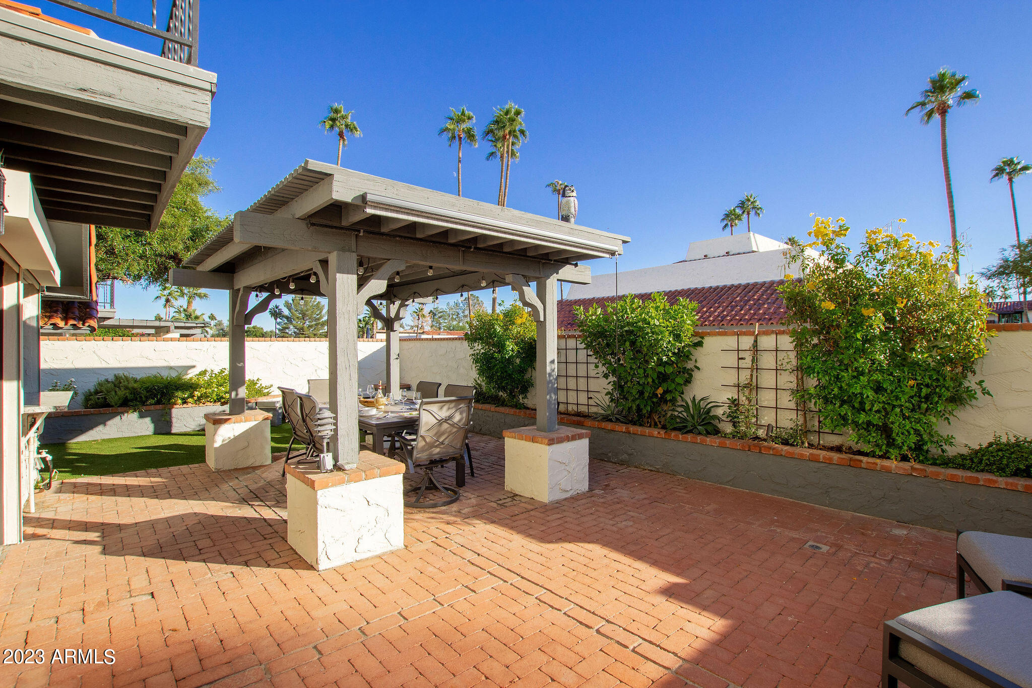 5822 North Scottsdale Road Paradise Valley, AZ 85253 - Photo 23 of 31 a view of a patio with table and chairs potted plants