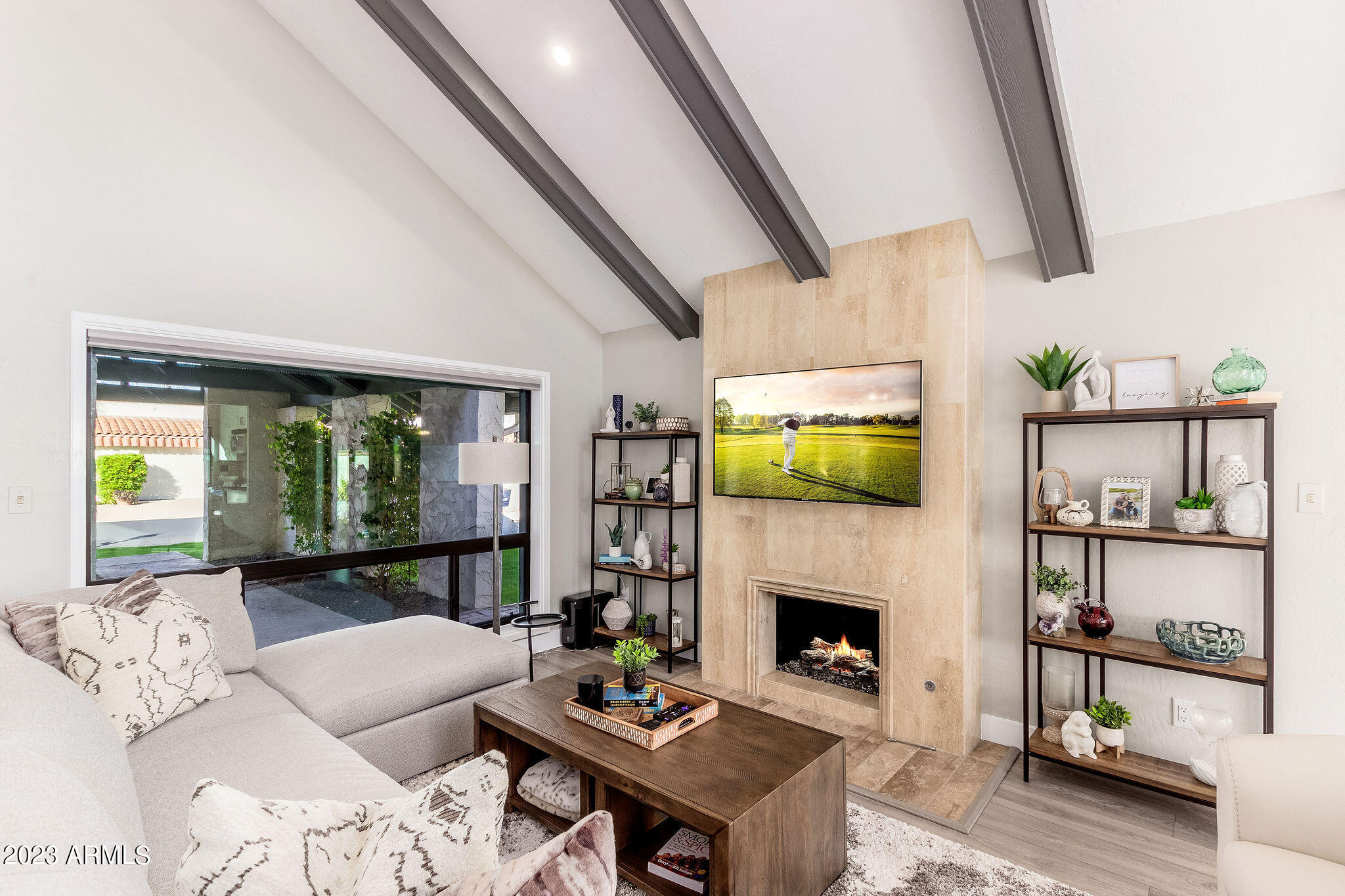 5822 North Scottsdale Road Paradise Valley, AZ 85253 - Photo 4 of 31 a living room with furniture a fireplace and a flat screen tv