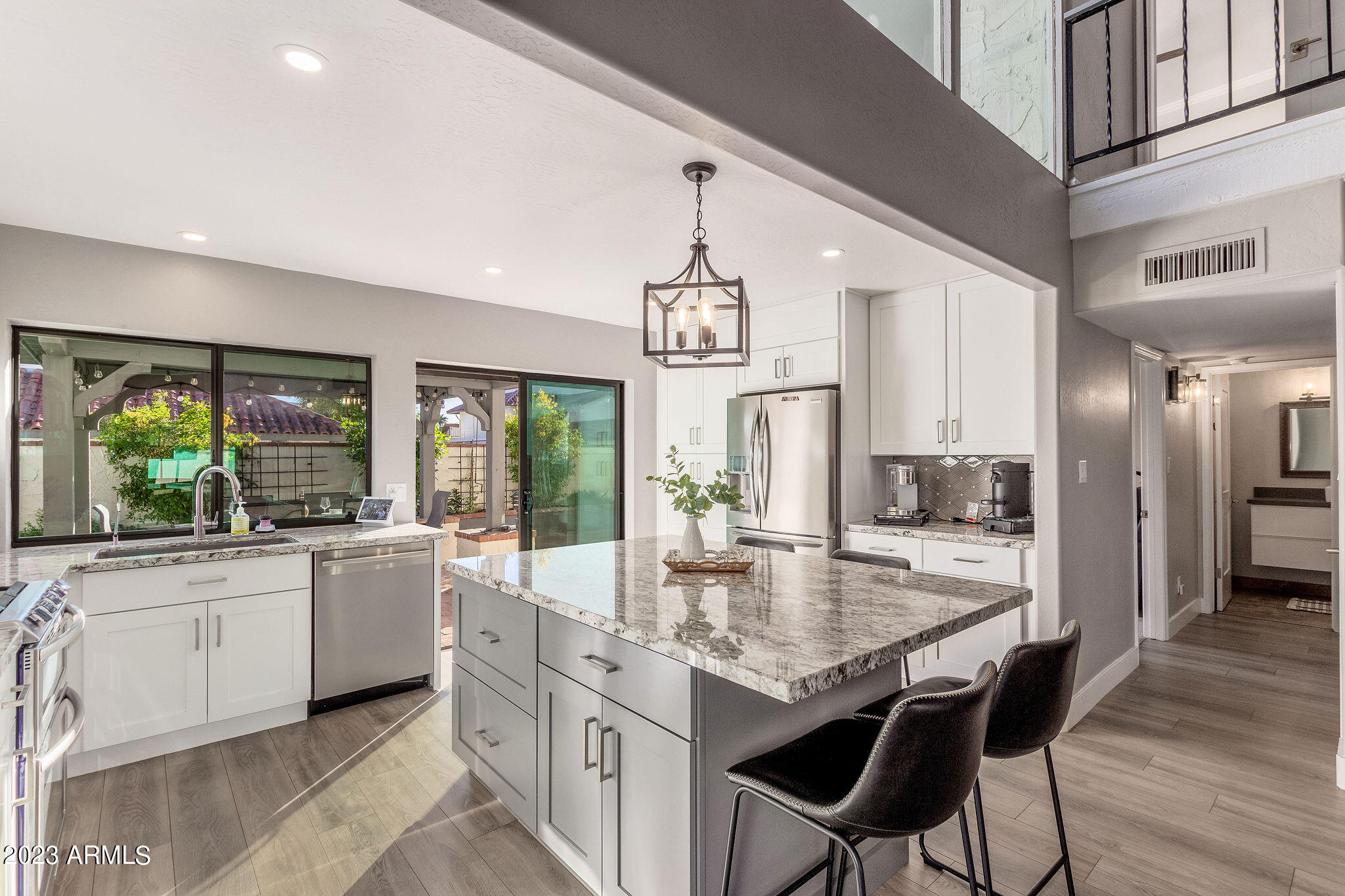 5822 North Scottsdale Road Paradise Valley, AZ 85253 - Photo 5 of 31 a kitchen with kitchen island granite countertop a stove and a view of living room
