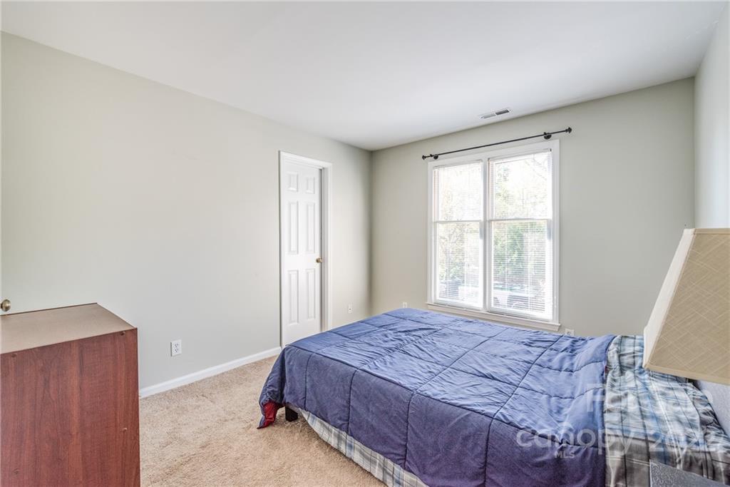 318 Queens Road, Unit 2 Charlotte, NC 28204 - Photo 14 of 18 a bed sitting in a bedroom next to a window