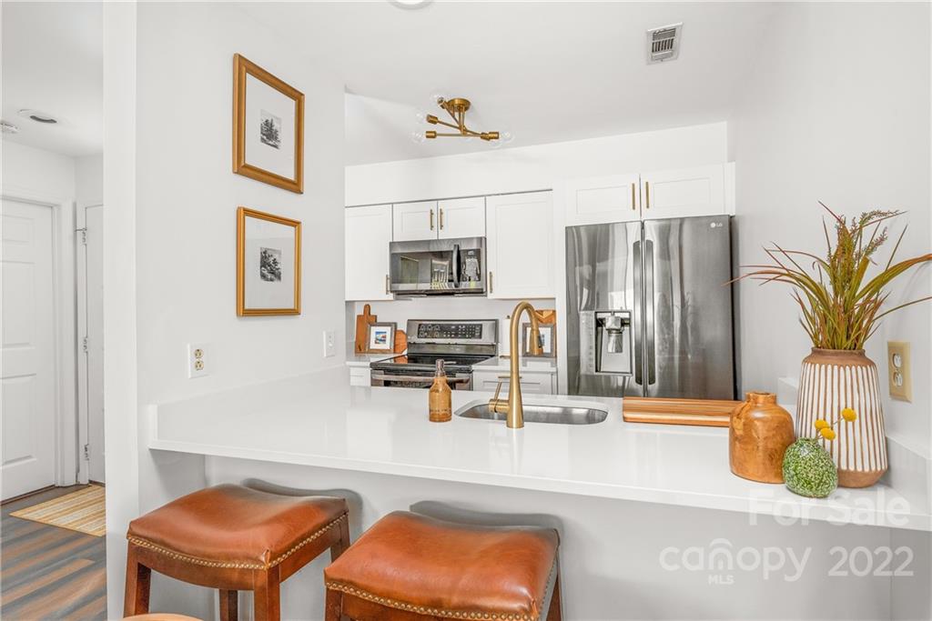 318 Queens Road, Unit 2 Charlotte, NC 28204 - Photo 5 of 18 a kitchen with stainless steel appliances granite countertop a refrigerator and a sink