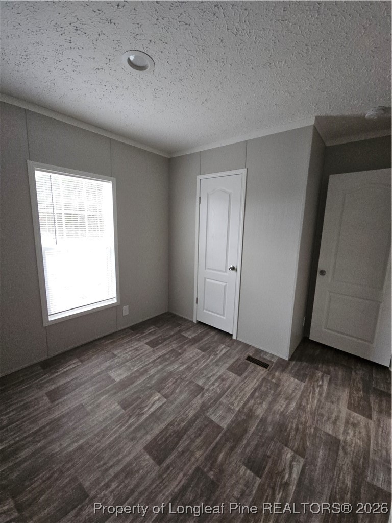 1438 Twisted Hickory Road Elizabethtown, NC 28337 - Photo 11 of 15 an empty room with wooden floor and windows