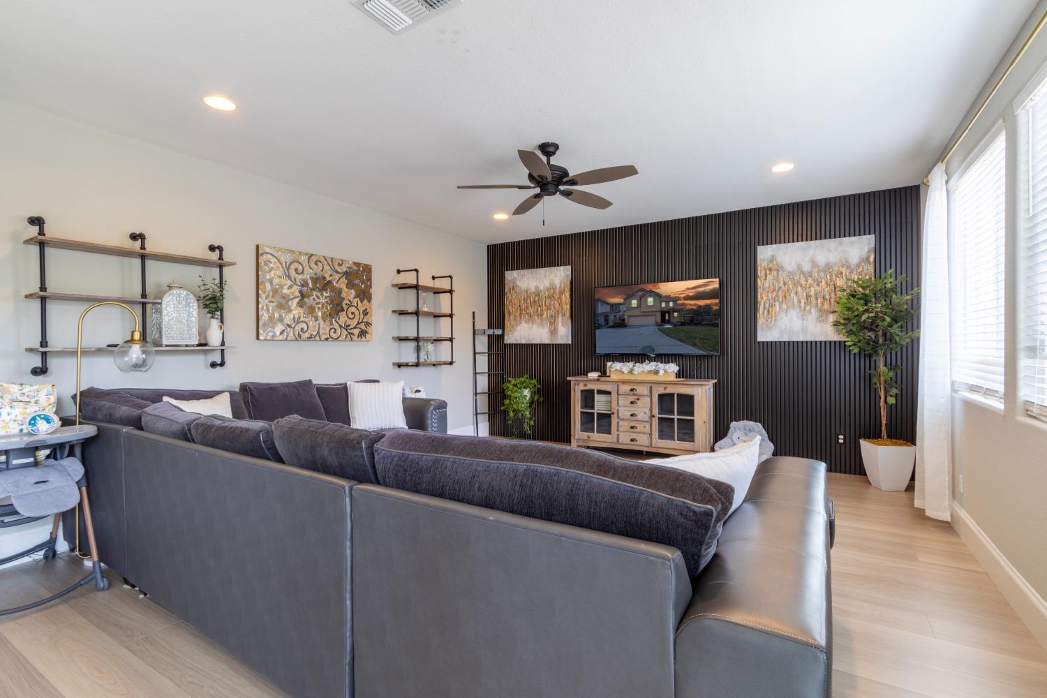 9419 Vintner Circle Patterson, CA 95363 - Photo 12 of 34 a living room with furniture and a flat screen tv
