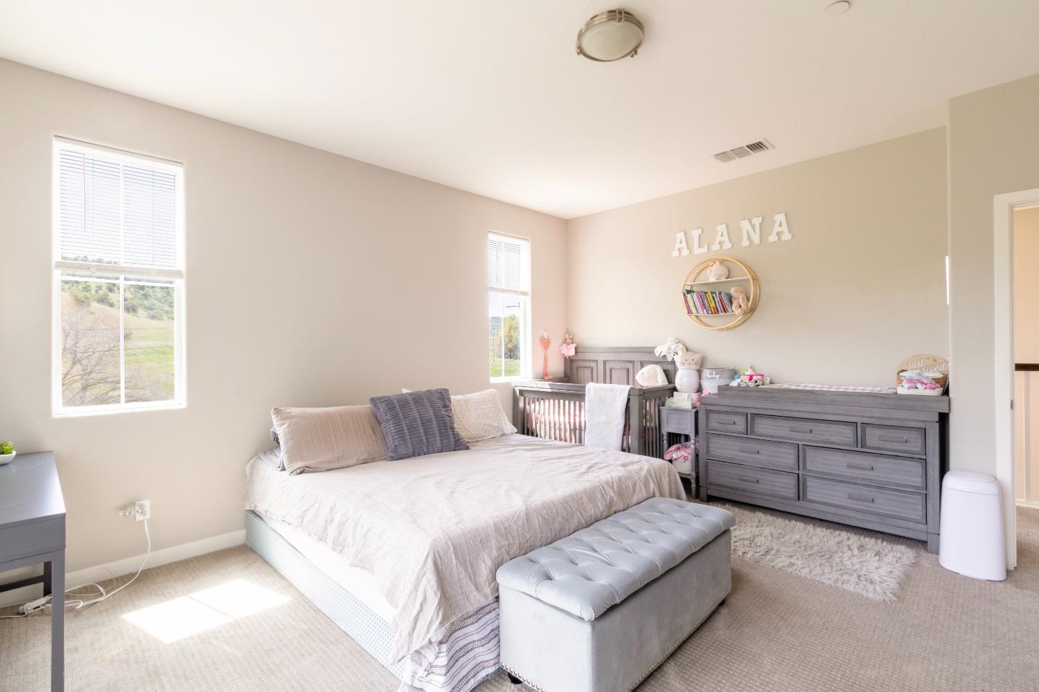 9419 Vintner Circle Patterson, CA 95363 - Photo 20 of 34 a bedroom with a bed and window