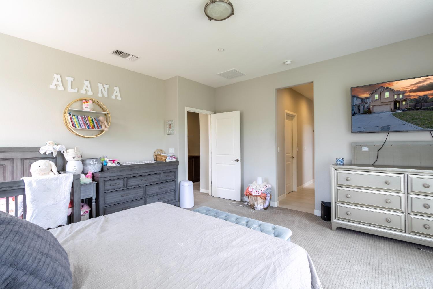 9419 Vintner Circle Patterson, CA 95363 - Photo 21 of 34 a bed room with a bed and a television