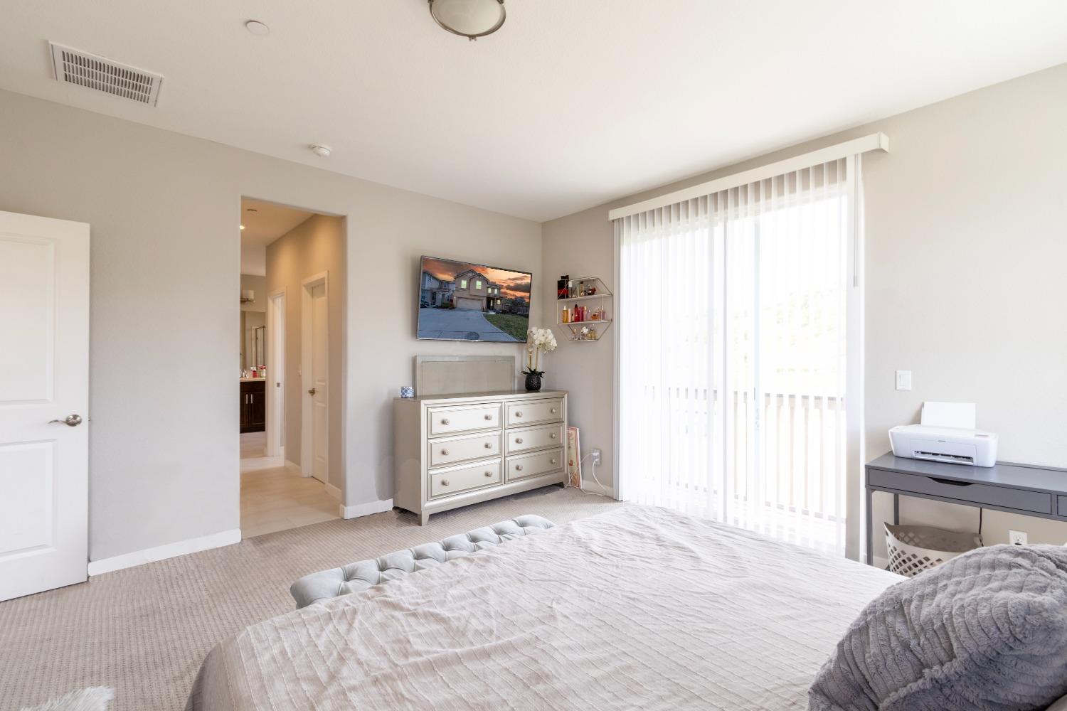 9419 Vintner Circle Patterson, CA 95363 - Photo 22 of 34 a bedroom with a bed and a window