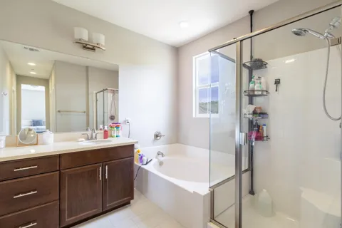 a view of a bathroom with a shower and mirror