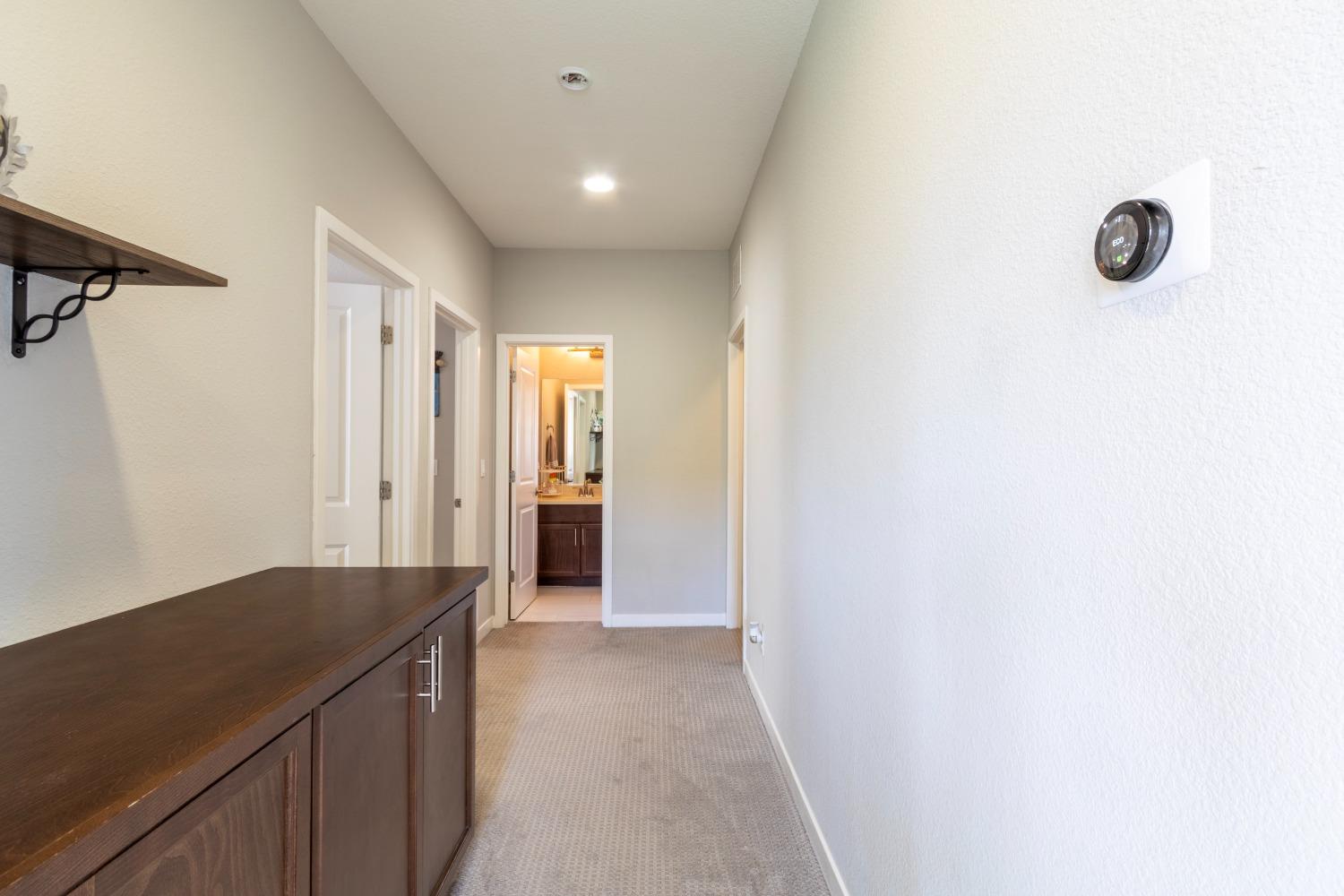9419 Vintner Circle Patterson, CA 95363 - Photo 25 of 34 a view of a bathroom with a shower and mirror