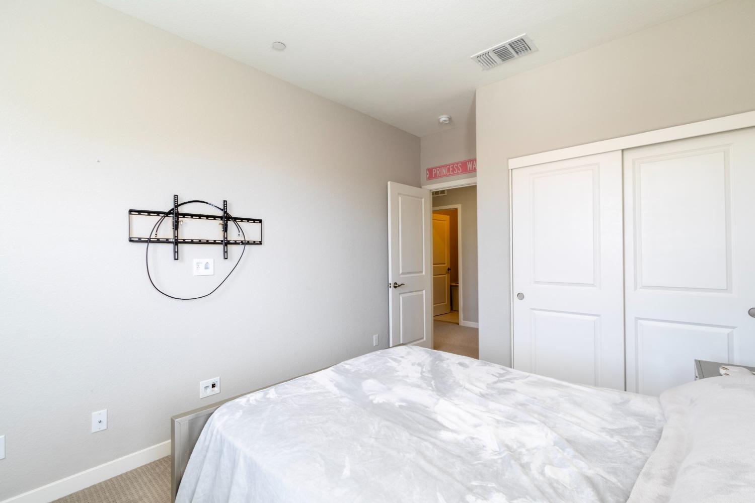 9419 Vintner Circle Patterson, CA 95363 - Photo 29 of 34 a bedroom with a bed and table