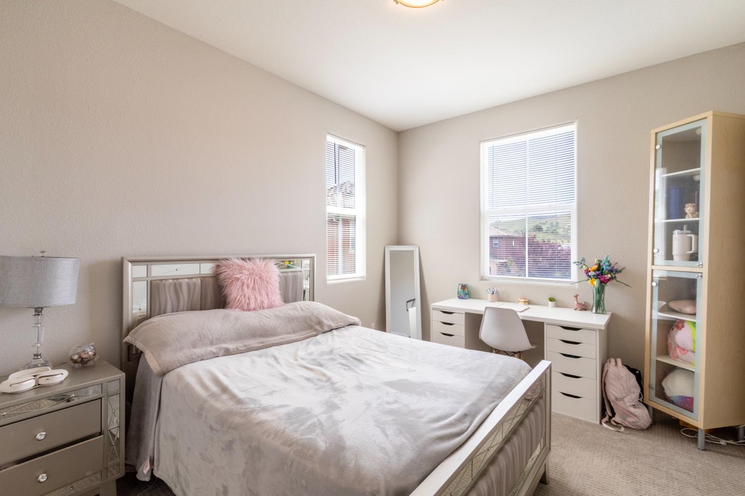 9419 Vintner Circle Patterson, CA 95363 - Photo 30 of 34 a bedroom with a bed and a window