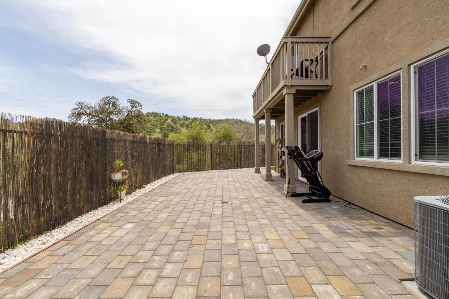 9419 Vintner Circle Patterson, CA 95363 - Photo 32 of 34 a view of a building with a bench in front of it
