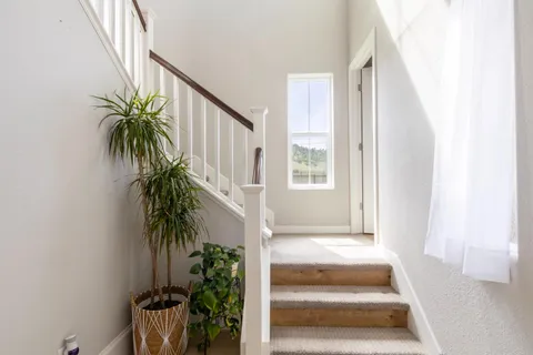 a view of entryway and hall with wooden floor