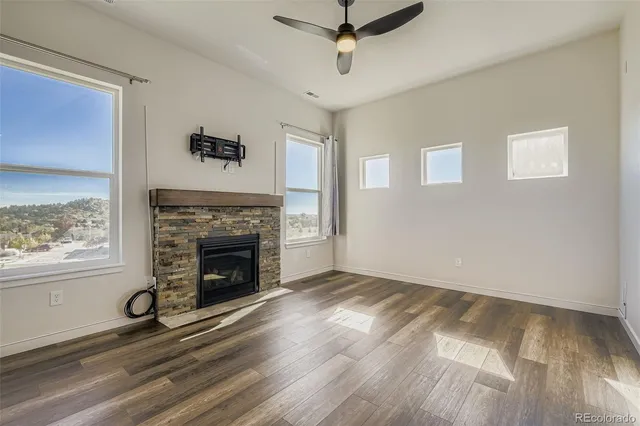 a view of a livingroom with a fireplace and window