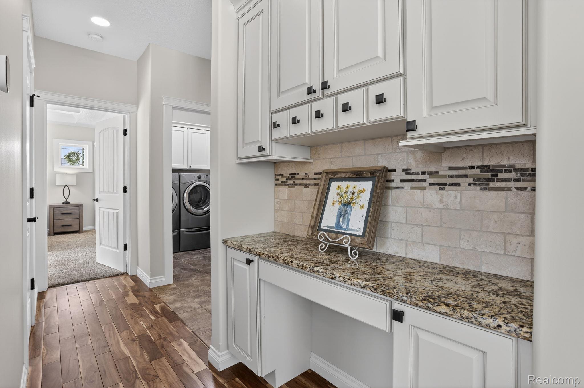 101 Highview Road Traverse City, MI 49696 - Photo 34 of 88 Kitchen featuring dark stone countertops, white cabinetry, and dark wood-style flooring