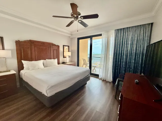 a spacious bathroom with a granite countertop sink mirror and shower