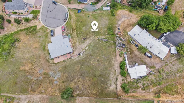 an aerial view of a house with garden space and street view
