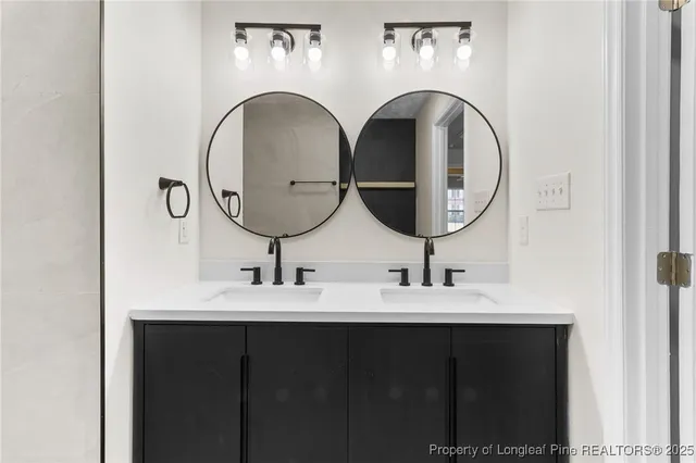 an empty room with wooden floor chandelier fan and windows