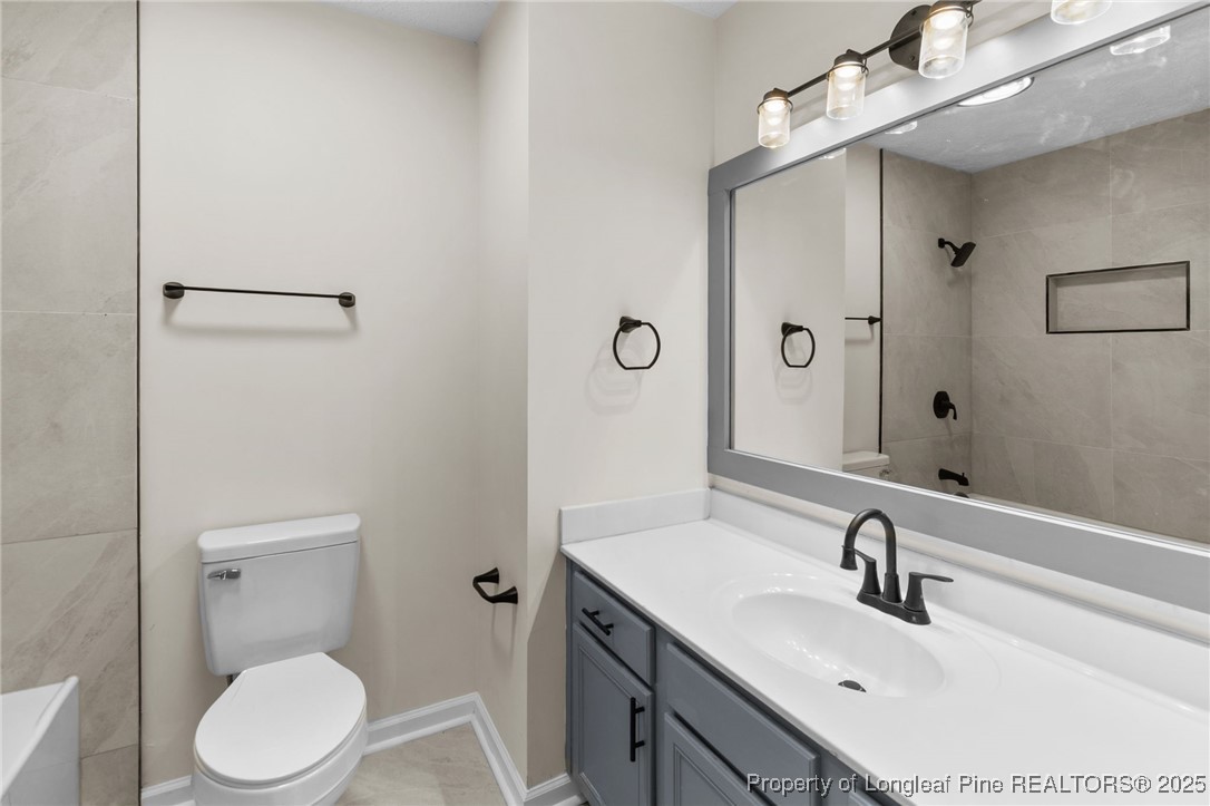 5520 Rising Ridge Drive Hope Mills, NC 28348 - Photo 16 of 30 a bathroom with a sink toilet and vanity