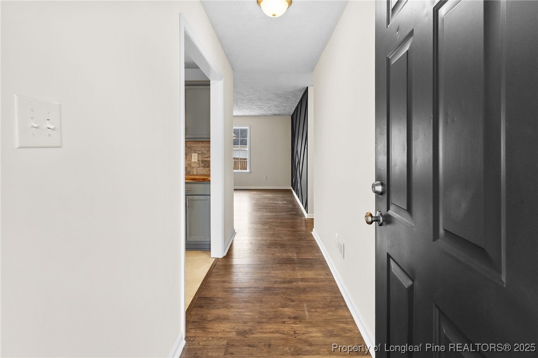 5520 Rising Ridge Drive Hope Mills, NC 28348 - Photo 2 of 30 a view of a hallway with wooden floor and staircase